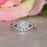 1.5 Carat Round Cut Twisted Halo Engagement Ring in White Gold Over Sterling Silver