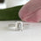 1.25 Carat Emerald Cut Accented Solitaire Engagement Ring in White Gold over Sterling Silver