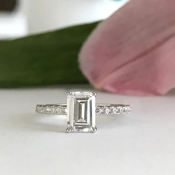 1.25 Carat Emerald Cut Accented Solitaire Engagement Ring in White Gold over Sterling Silver