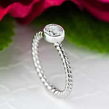 0.25 Carat Round Cut Bezel Infinity Engagement Ring in White Gold over Sterling Silver