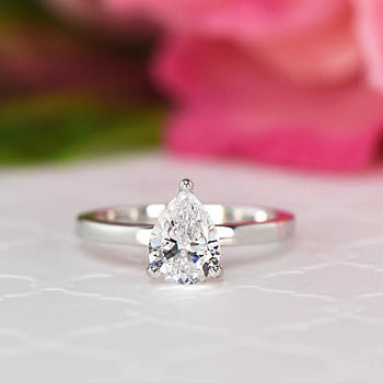 1.25 Carat Pear Cut Solitaire Engagement Ring in White Gold over Sterling Silver