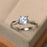 Twisted 1.25 Carat Round Cut Blue Moonstone and Diamond Infinity Engagement Ring in White Gold