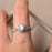 Channel Setting 1.50 Carat Round Cut Blue Moonstone and Diamond Twisted Engagement Ring in White Gold