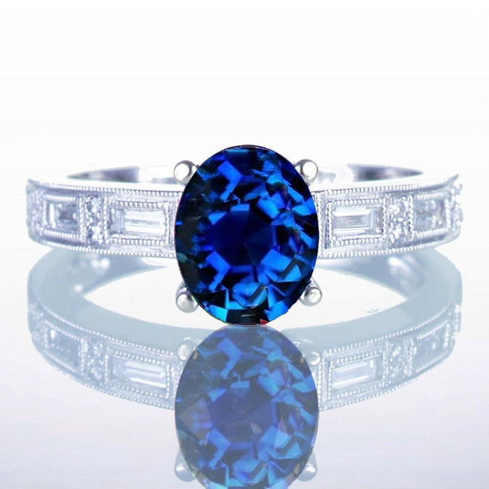 1.50 Carat Oval Cut Sapphire and Baguette Diamond Milgrain Engagement Ring