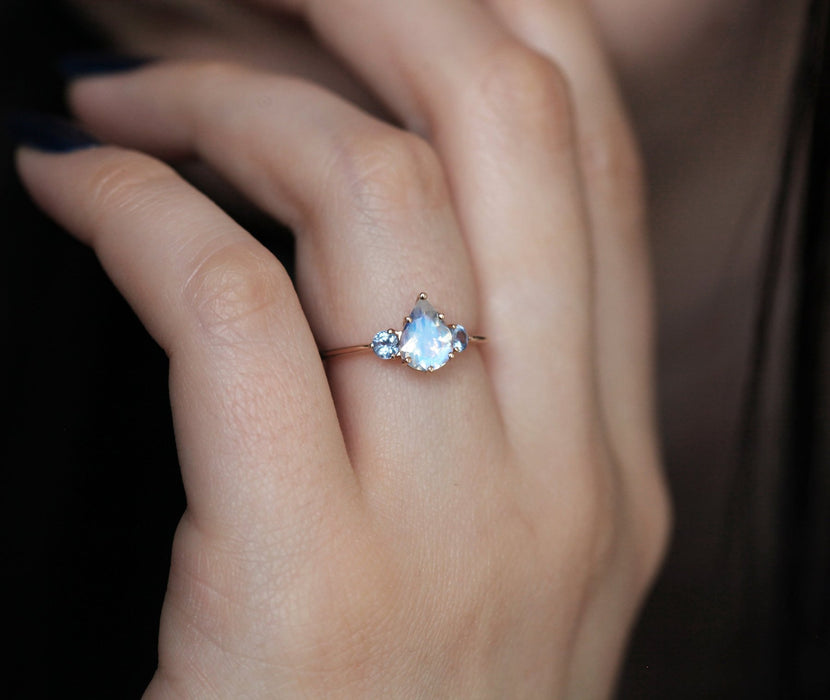 1.10 Carat Pear Shape Rainbow Moonstone and Sapphire Three Stone Engagement Ring in Rose Gold