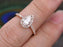 1.50 Carat Pear Cut Moissanite and Diamond Halo Engagement Ring in Rose Gold