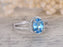 1.50 Carat Oval Cut Sky Blue Topaz and Diamond Halo Claw Prong Split Shank Engagement Ring in White Gold