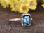 1.50 Carat Emerald Cut London Blue Topaz and Diamond Halo Half Infinity Engagement Ring in Rose Gold