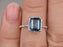 1.50 Carat Emerald Cut London Blue Topaz and Diamond Halo Half Infinity Engagement Ring in White Gold